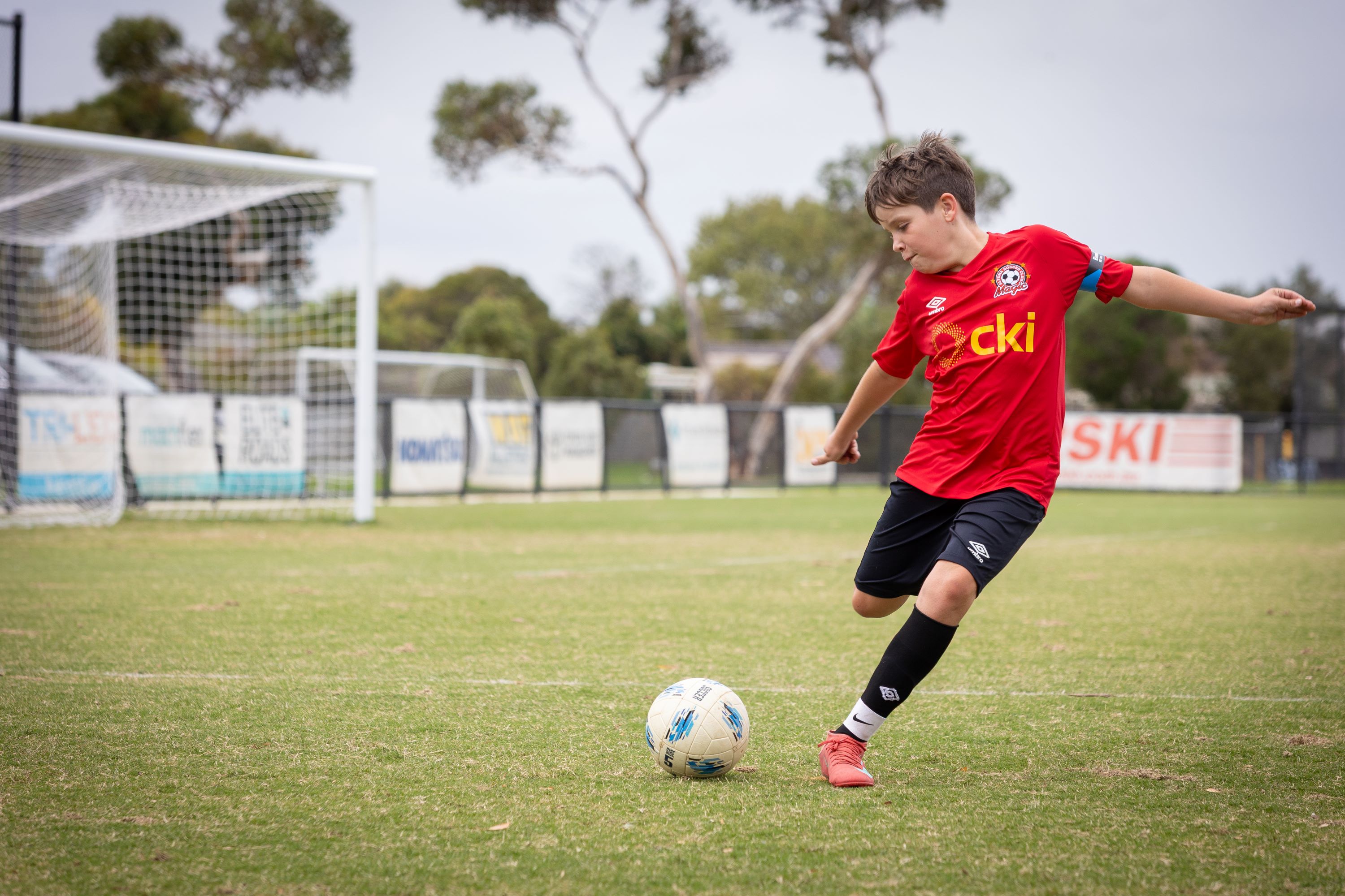 Young child kicks soccer ball