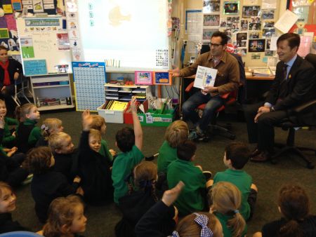 reading a book to children in class