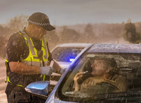 An image of a Victoria Police officer performing a roadside drug test.