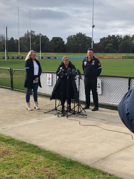 TAC's Samantha Cockfield and St Kilda AFL coach Brett Ratten shown at Moorabbin oval to launch Band Together 