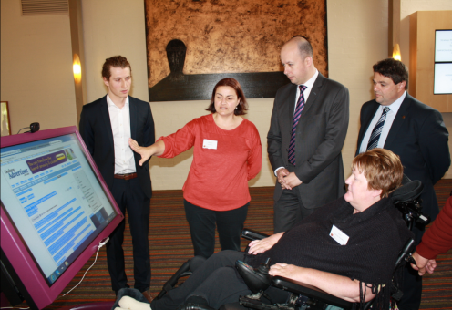 Barwon Health Occupational Therapist Debbie Verikios and TAC client Ann-Maree Hoskin explain the new TAP-it technology to Assistant Treasurer Gordon Rich-Phillips and Member for South Barwon Andrew Katos. TAP-it technology in action