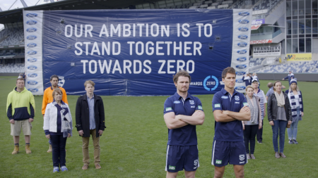 People standing in front of banner 