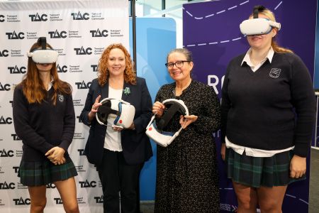 Two school students wearing headsets with Minister for Roads and Road Safety Melissa Horne and TAC Head of Road Safety Samantha Cockfield.
